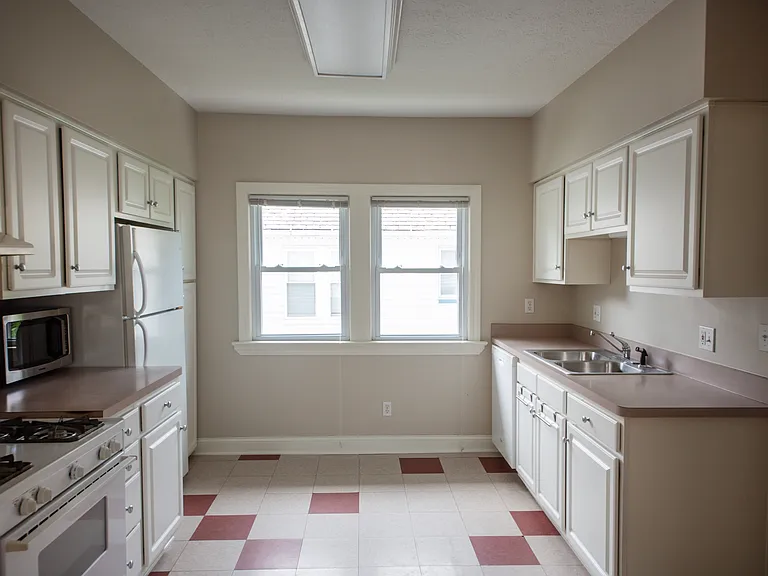 Bright and functional kitchen featuring abundant cabinet space, white cabinetry, and plenty of natural light.