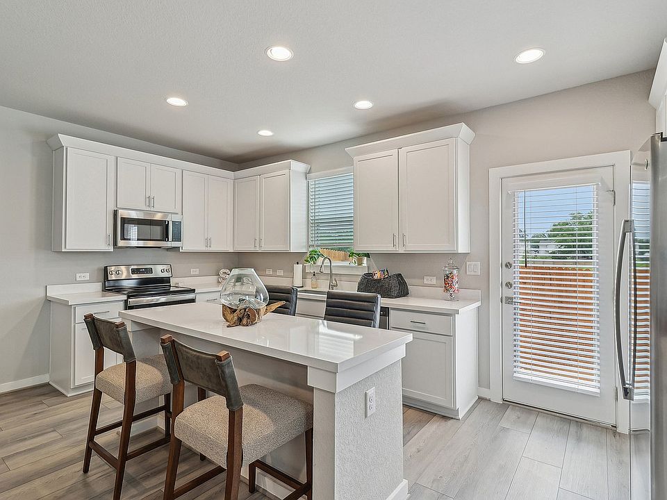 Spacious Kitchen with Island and Stainless Steel Appliances