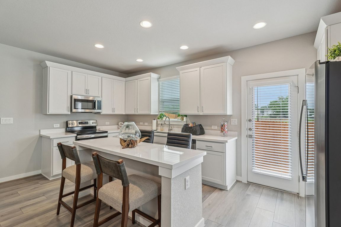 Spacious Kitchen with Island and Stainless Steel Appliances