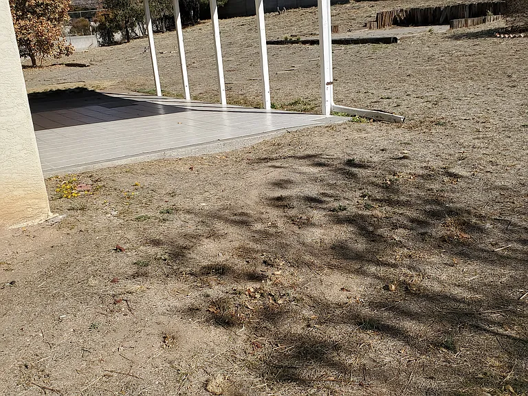 patio, concrete walls, trees and view of back yard