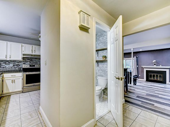 View from foyer
Foyer is open to the kitchen and dining room with view into the living room. Powder room is convenient to this level