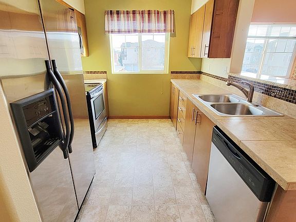 Kitchen features dishwasher, stainless steel refrigerator