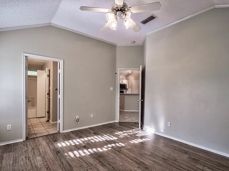 Primary bedroom, connected to bath and living areas