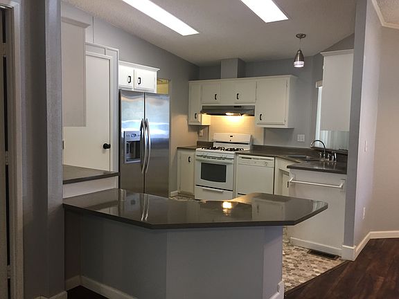 Open concept kitchen - with stainless steel appliances and a pantry