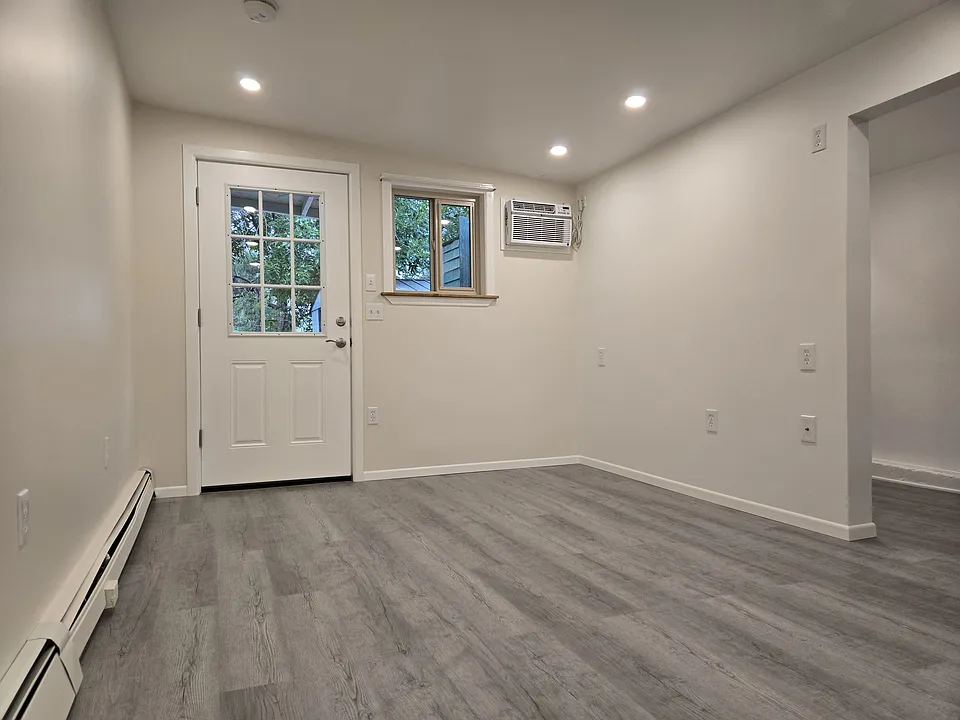 Main room looking west. Exit to private patio, backyard, storage sheds and laundry.