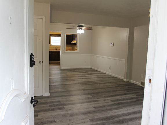 Large Living Room with wood plank flooring, new paint