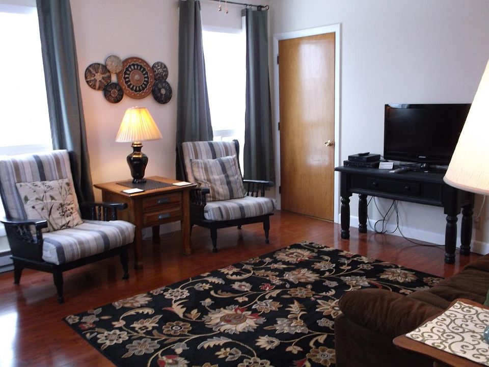 The bright comfortable living room has south-facing windows that let in lots of natural light.