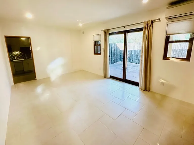 Large master bedroom with plenty of natural light, mini split and sliding glass doors. This space can easily accommodate a king sized bed and additional furniture.