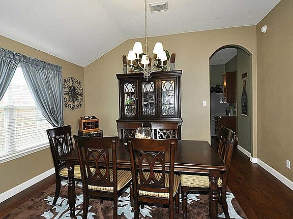 Through the graceful archway are the kitchen, breakfast room and family living area.