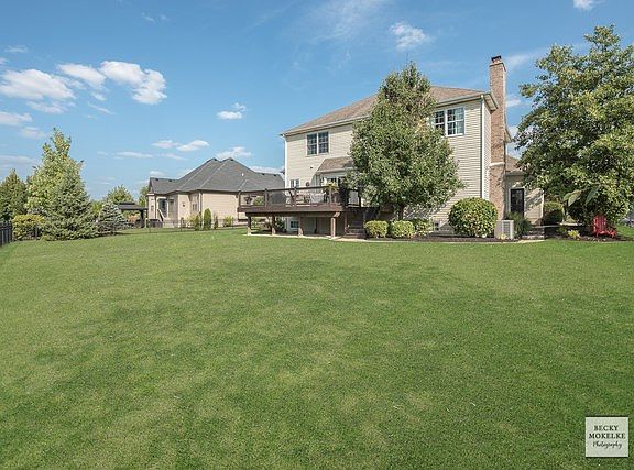 Enjoy a landscaped yard w/mature trees, large deck & fenced yard!