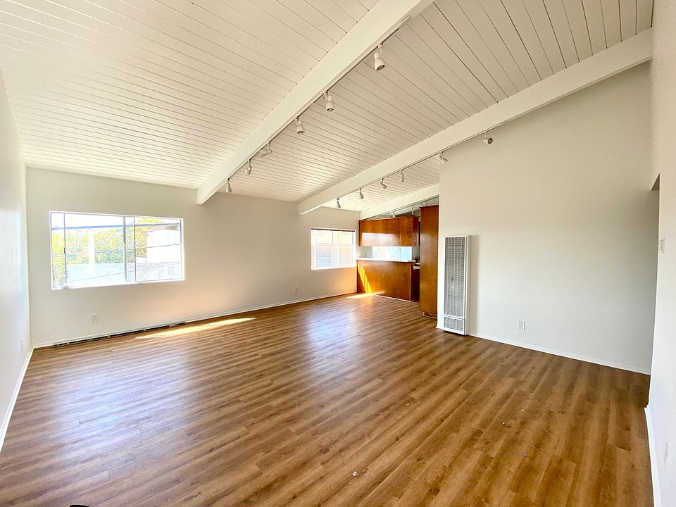 View when entering the front door. Vaulted 12ft ceilings + west facing windows for great breezes and sunset views.