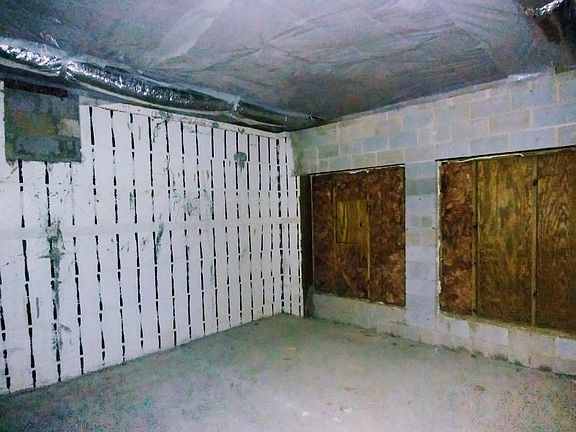 Large unfinished basement windows would look out over the Little River setting.