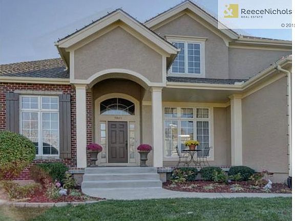 Lush landscaping leads the way to this grand entry which include