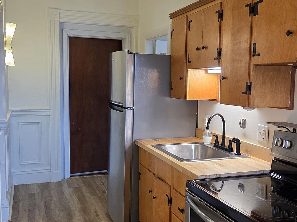 Kitchen With Stainless Steel Appliances New Flooring And Hardwood Cabinets