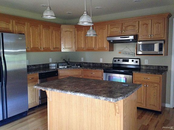 Stainless steel appliances and island with lots of spacious cabinets