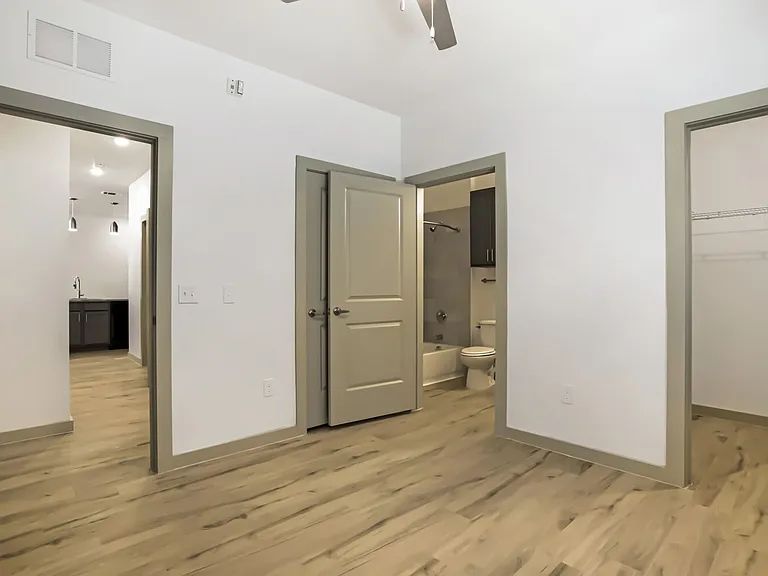 bedroom with bathroom and walk in closet