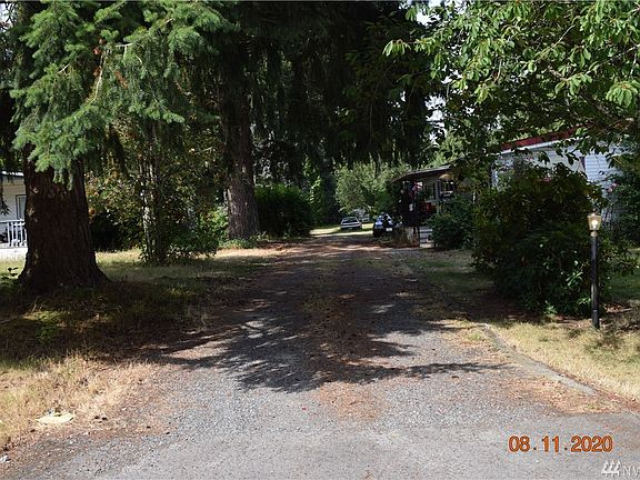 Long driveway to carport and detached garage