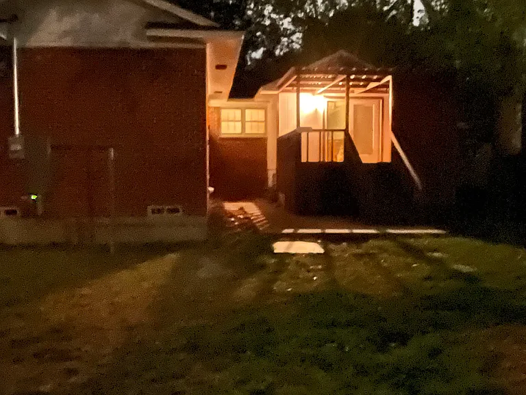 The back patio lit at night.