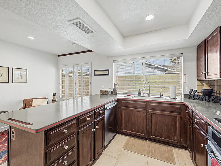 Spacious kitchen with generous counter space, ample cabinetry, and a large window over the sink for everyday prep.