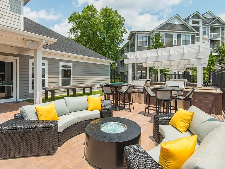 Outdoor entertainment space that's outfitted with a grilling station and abundant seating.