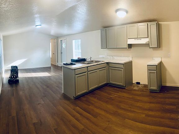 Kitchen (fridge and stove will be installed before tenants move in) looking towards living room and master bedroom.