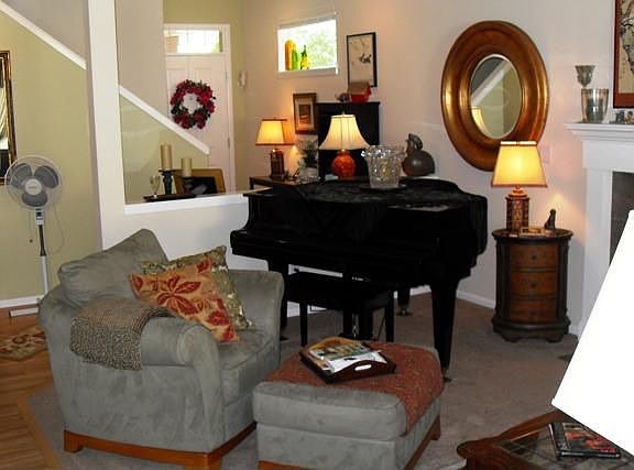 Another view of living room, front entry and staircase leading to upper level. This is a wonderful g