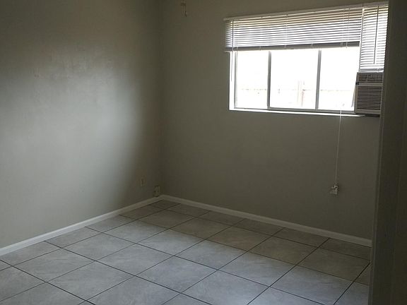Bedroom 1 with window AC unit & ceiling fan