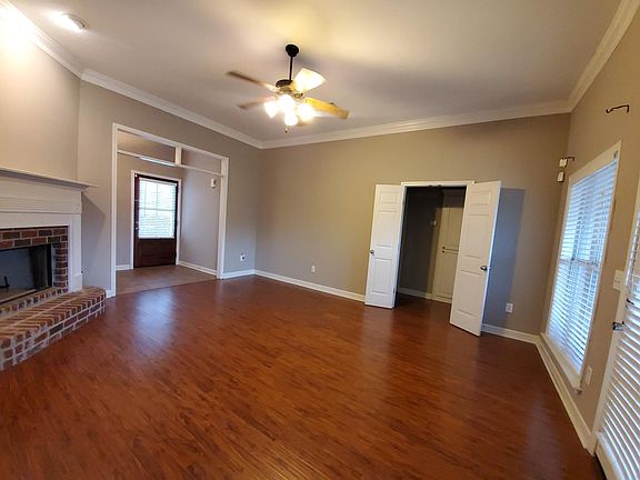 Enter front door into Family Room with hardwood floors. Fireplace, ceiling fan. To the left, double doors to hallway to 2 bedrooms and hall bathroom. Straight ahead is the door to back yard. ALL windows have a blind.