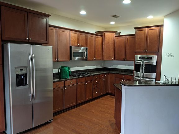 Spacious modern kitchen with stainless steel appliances, tons of cabinet space 2 ovens and a gas cook top for the chef of the family.