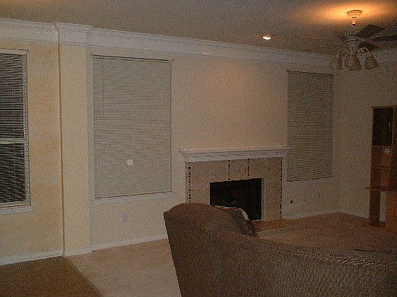Family room w/beautifully tiled fireplace, crown molding, big windows