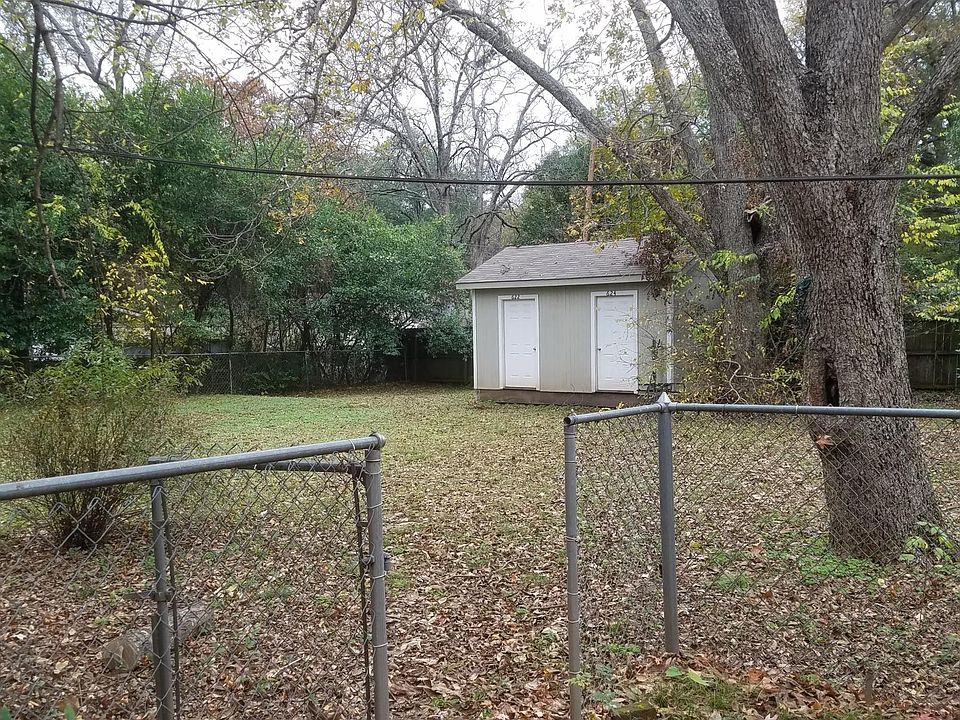 Fenced yard with dedicated storage unit.