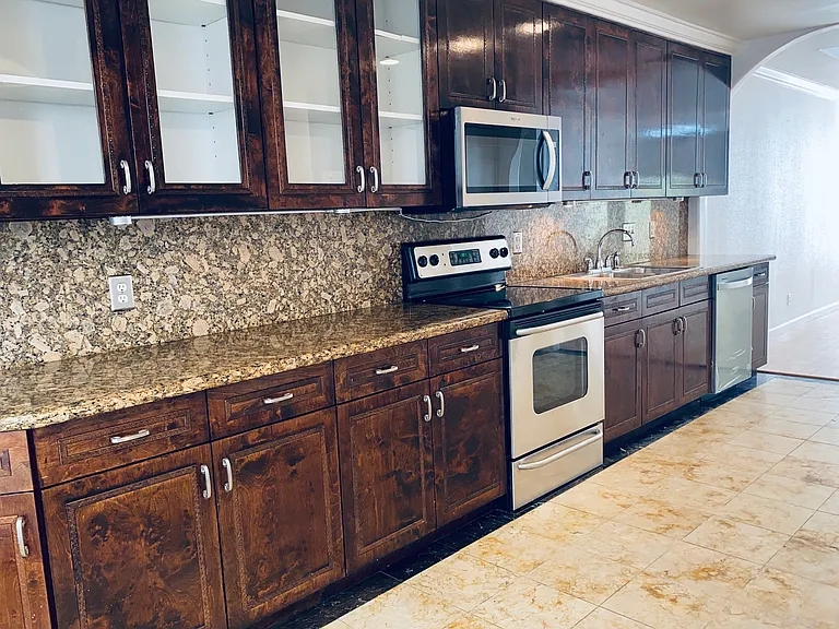 The kitchen features a breakfast nook with ample cabinetry, sleek granite countertops a pantry and stainless-steel appliances.