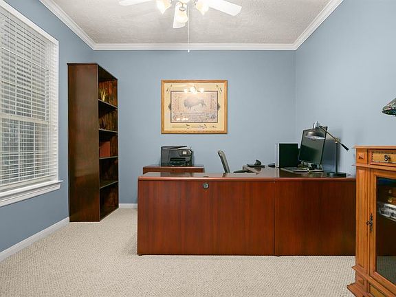Handsome study with crown molding and French doors for added privacy.