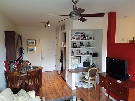 Kitchen with stainless steel appliances, track lighting and 