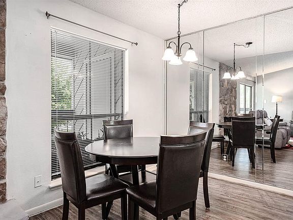 Make memories gathered around the table with your family and friends! This dining room features high ceilings, a wall of mirrors, large window, and a beautiful chandelier!