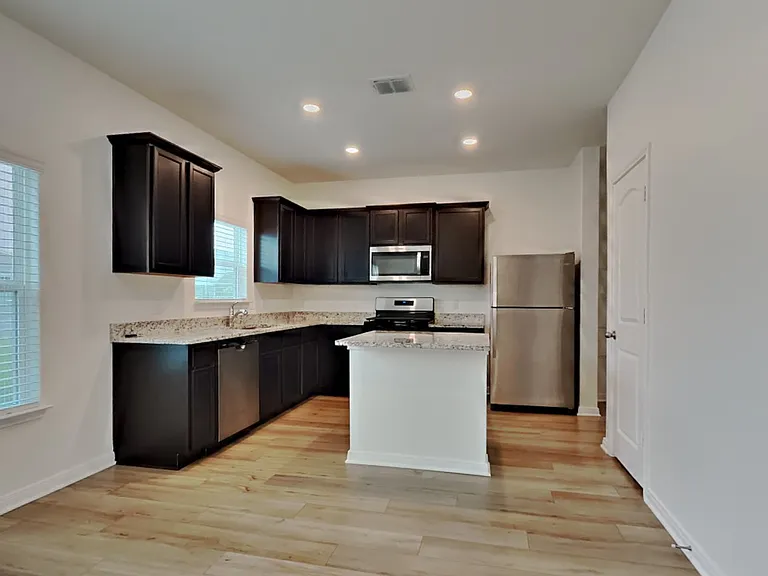 Spacious kitchen with dark cab