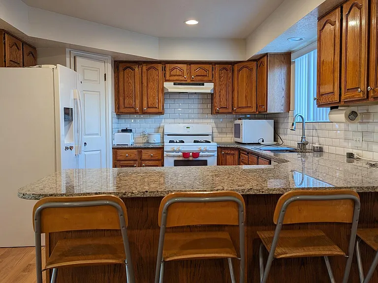 Kitchen with large pantry closet and counter seating