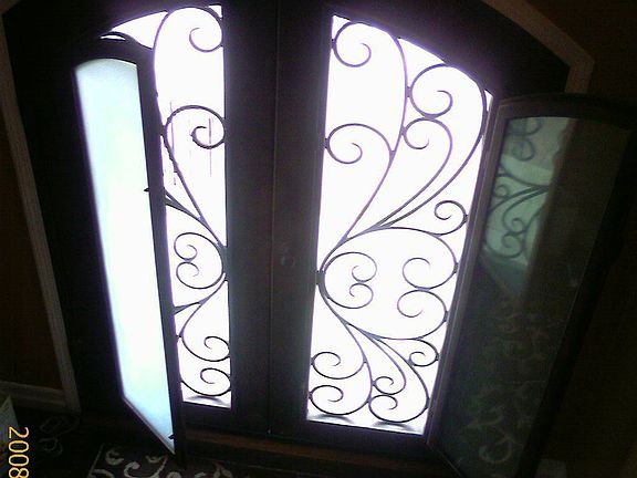 Wrought Iron French Double Doors With Dual Glaze Windows That Open to Vent