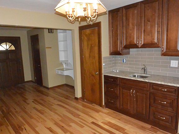 Built in wet bar with lots of storage, granite counter top and tiled back splash.