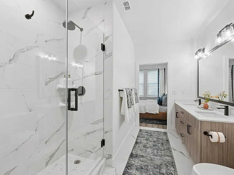 Bathroom with Quartz Countertops, Double Vanity Sinks, Walk-in Shower, and Walk-in Closet
