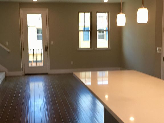 View of living room and balcony from kitchen