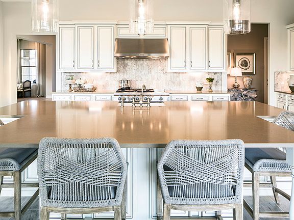 The over-sized kitchen island offers additional seating and extra space for cooking