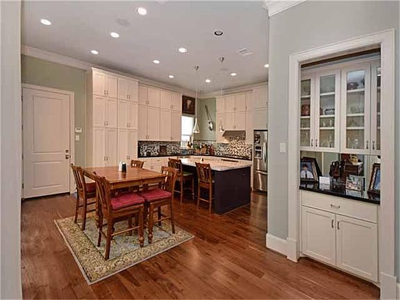 From the formal dining you can appreciate the butler pantry and the stunning walnut floors!