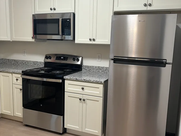 New Microwave located above the electric stove