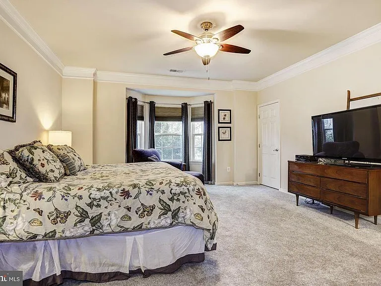 Master suite with dual walk-in closets, bay window and en suite master bathroom.