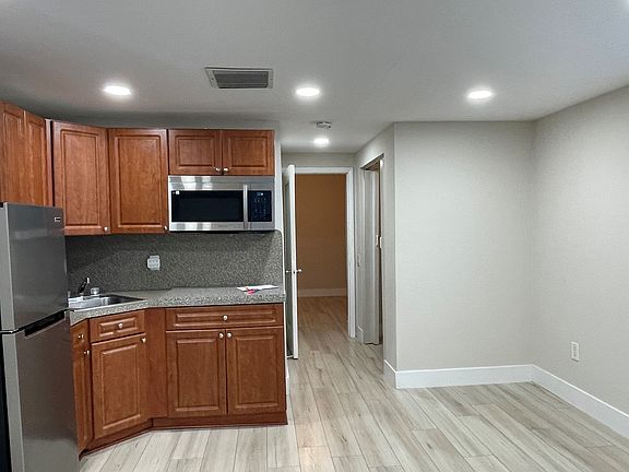 looking into the bedroom with door open - closet in hallway- new microwave