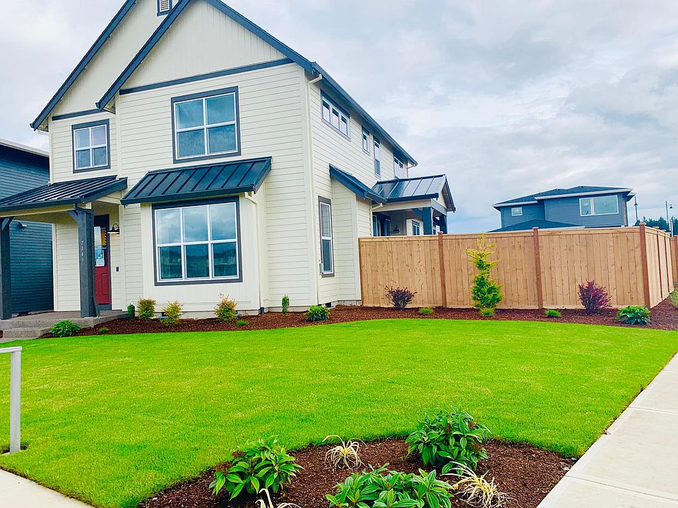 Front view of the home with Landscape, fence and sidewalk.
