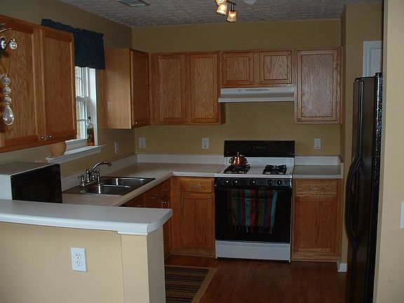 Rennovated kitchen with new floors, new paint and new lighting
