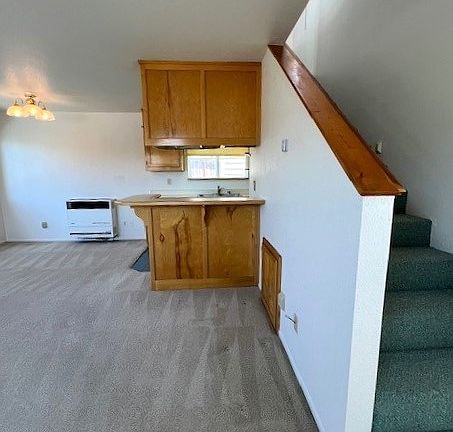 Entry door on left, looking at stairs to second floor and kitchen