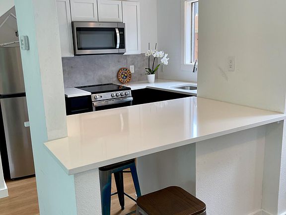 Work/bar area with quartz countertops.